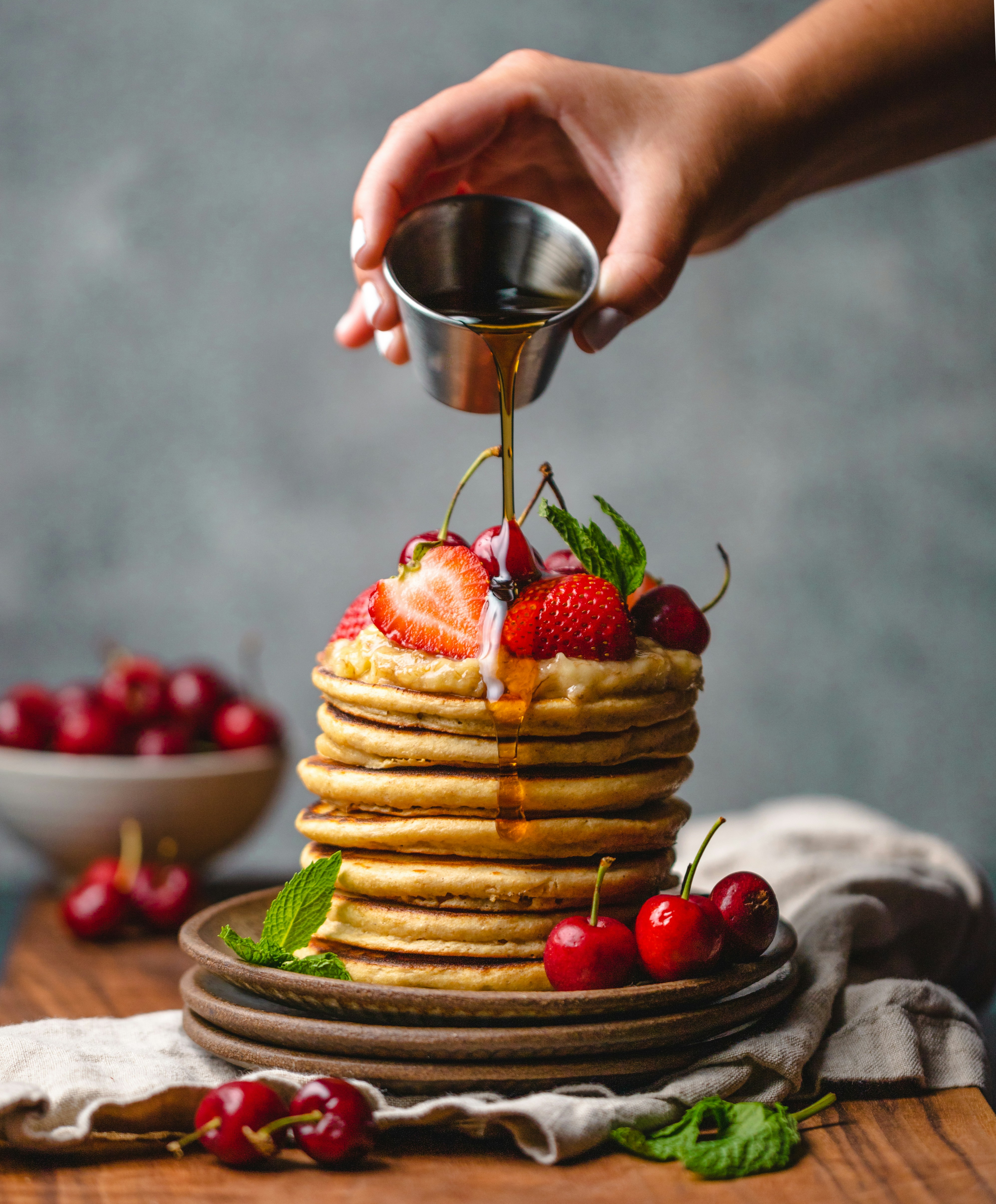 Stack of fluffy pancakes with maple syrup